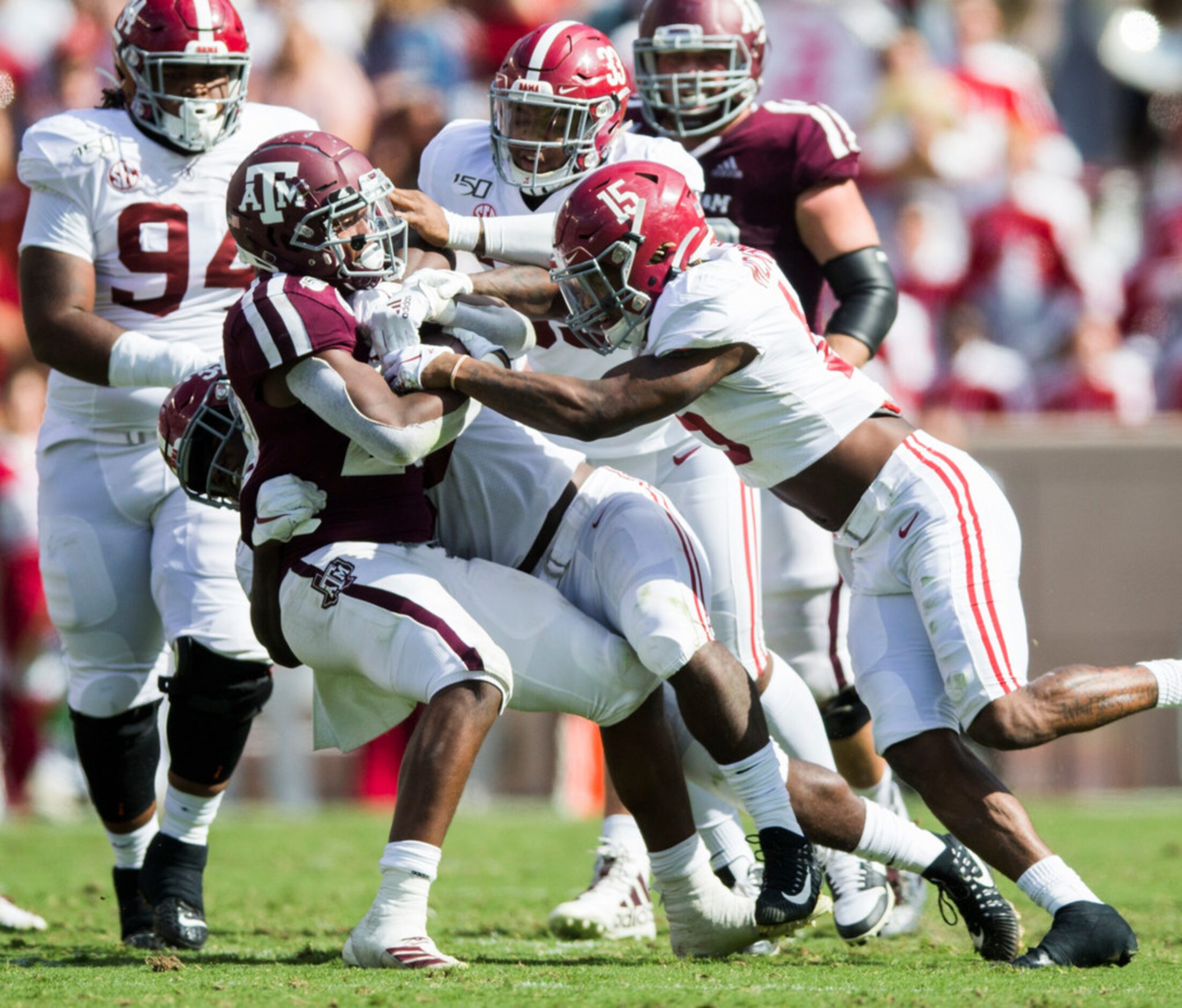 Texas A&M Aggies running back Isaiah Spiller (28) is tackled by Alabama Crimson Tide...