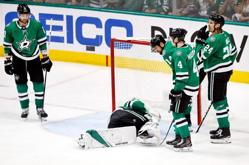 Dallas Stars goaltender Ben Bishop (30) lays on the ice after being hit by a St. Louis Blues...