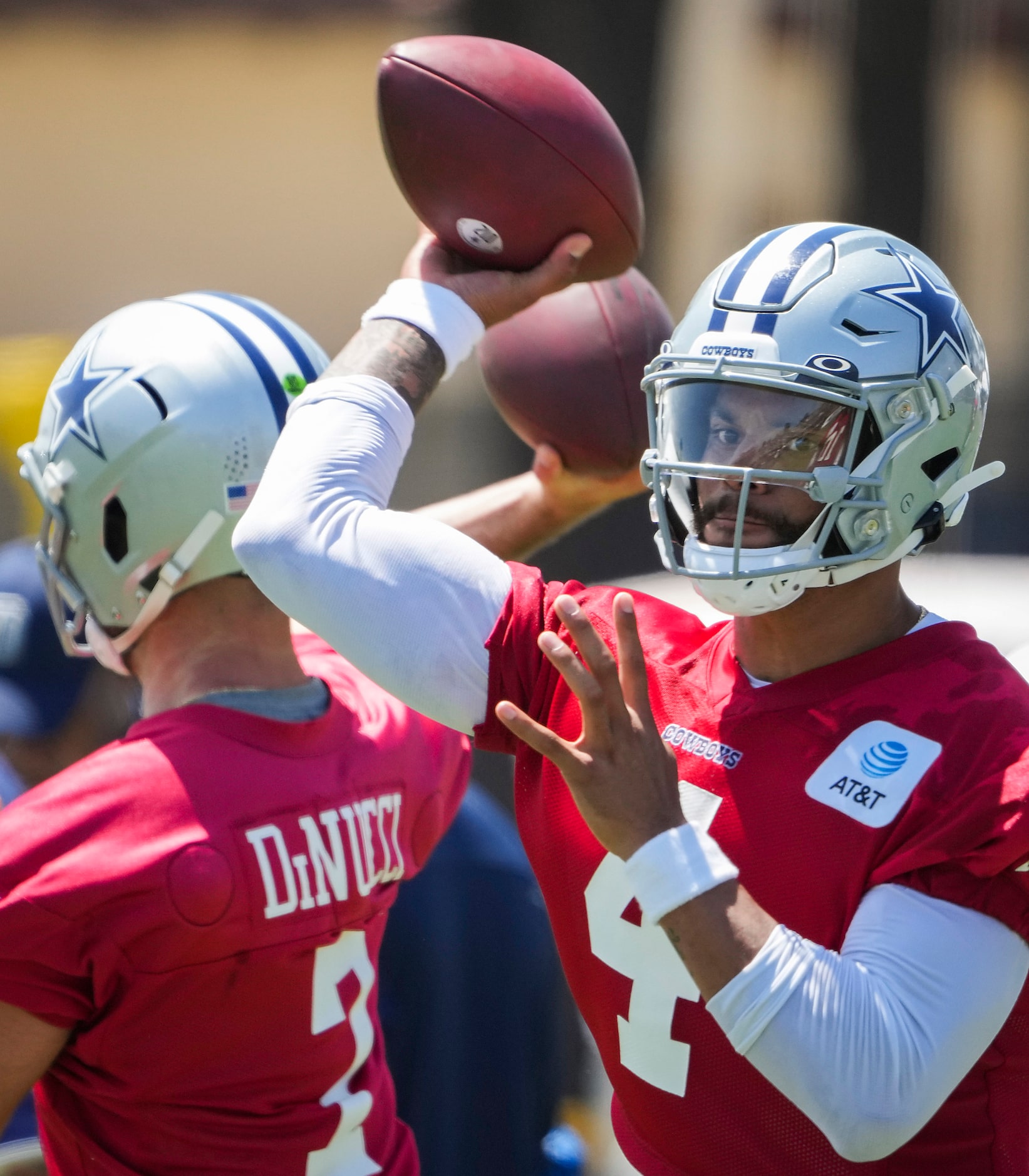 Dallas Cowboys quarterback Dak Prescott (4) throws a pass alongside quarterback Garrett...