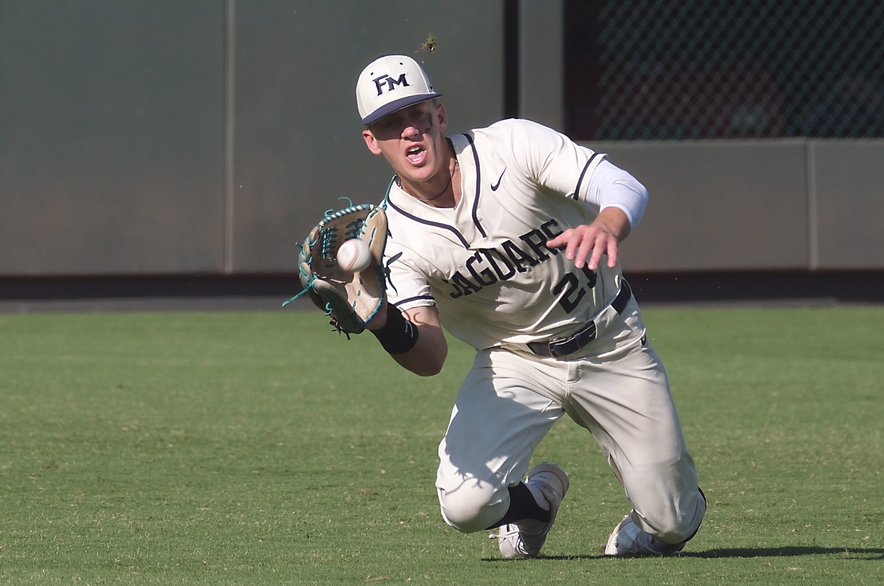 Flower Mound Sam Erickson, (21), makes a diving catch against Pearland during the sixth...