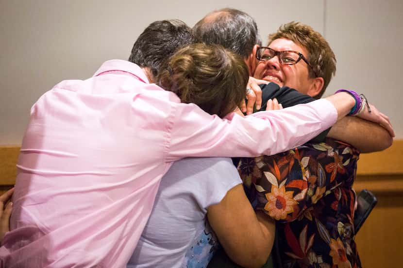 Christina Morris' mother, Jonni McElroy (facing), hugs family members after Arochi's guilt...