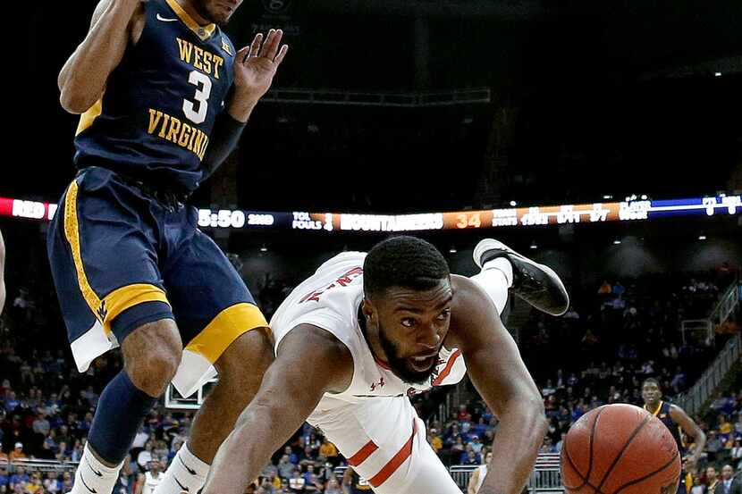 Texas Tech's Niem Stevenson and West Virginia's James Bolden (3) chase a long pass during...