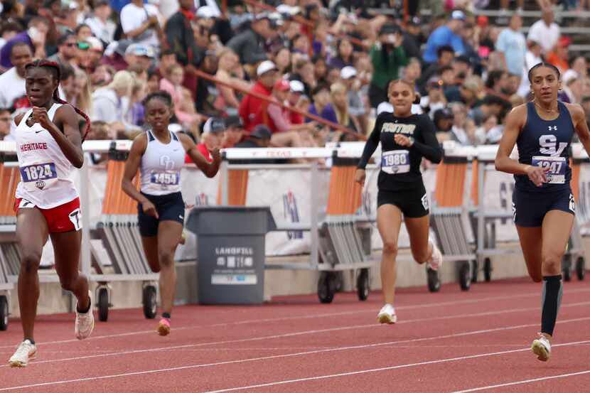 Midlothian Heritage sprinter Angel Brefo, left, leads the field en route to her first place...