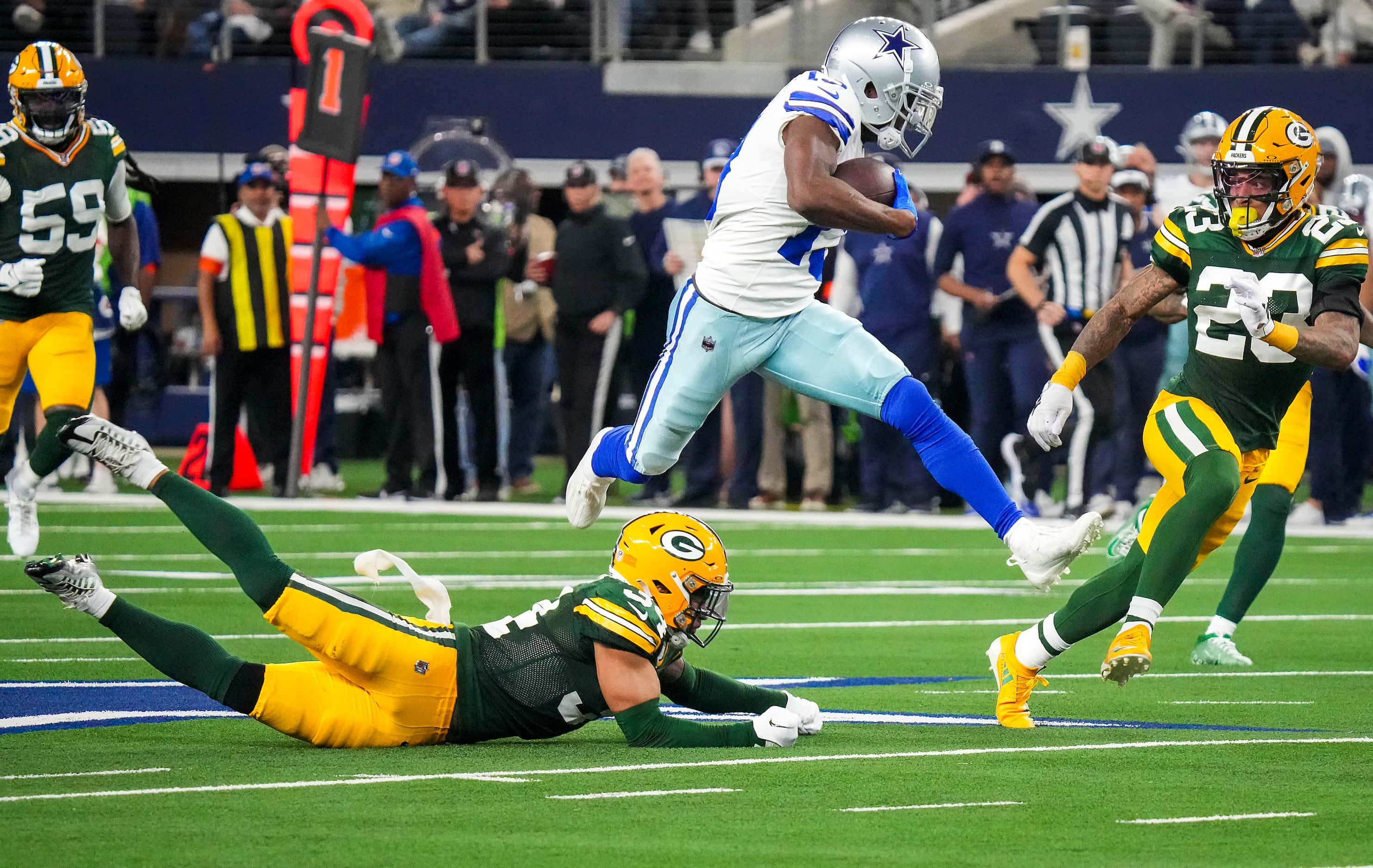 Dallas Cowboys wide receiver Michael Gallup (13) leaps over Green Bay Packers safety...