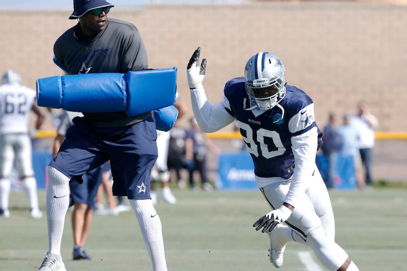 Dallas Cowboys defensive end Demarcus Lawrence (90) works with Dallas Cowboys Leon Lett in a...