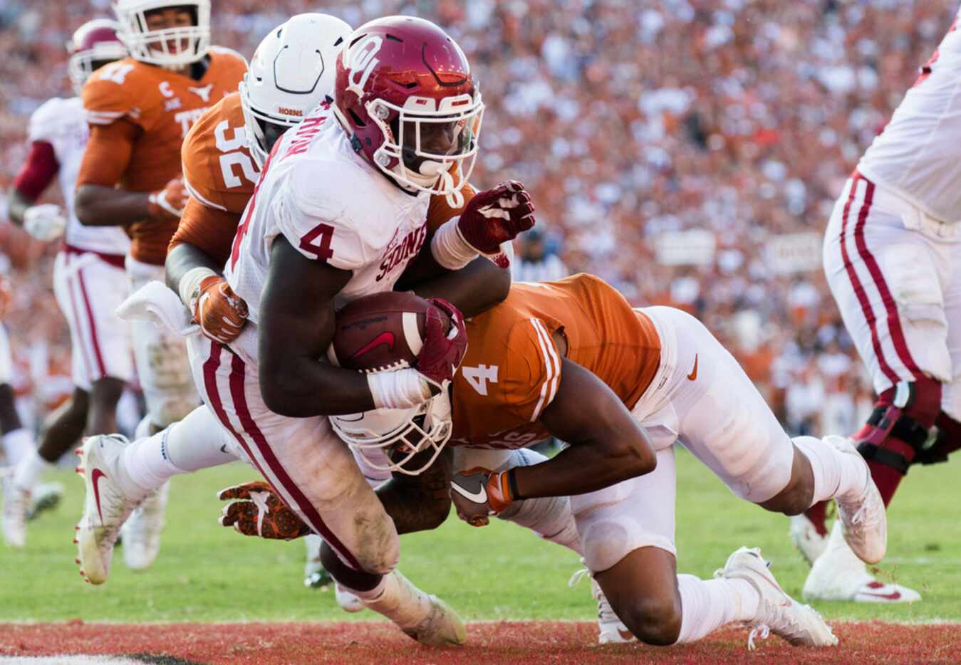 Texas Longhorns defensive end Malcolm Roach (32) and defensive back DeShon Elliott (4)...