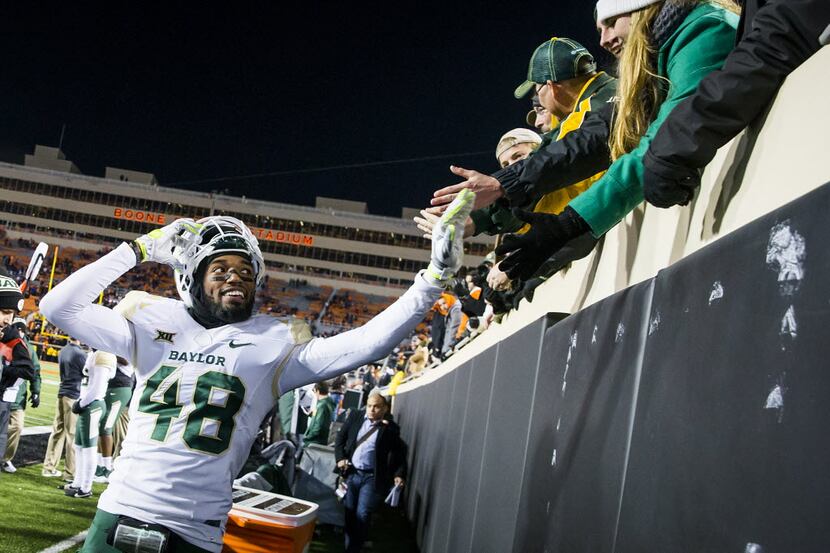 Baylor's Travon Blanchard (48) celebrates with fans in the final seconds of a victory over...