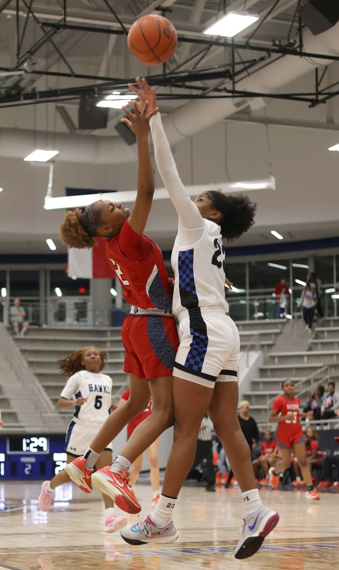 Denton Ryan guard Dez King (2), left, puts up a shot as Hebron guard Paris Bradley (23)...