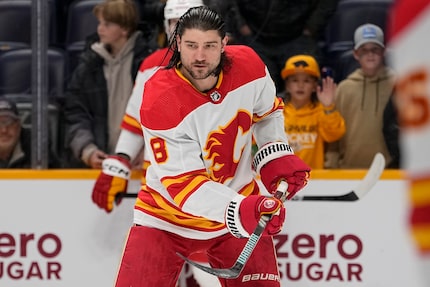 Calgary Flames defenseman Chris Tanev (8) warms up before an NHL hockey game against the...