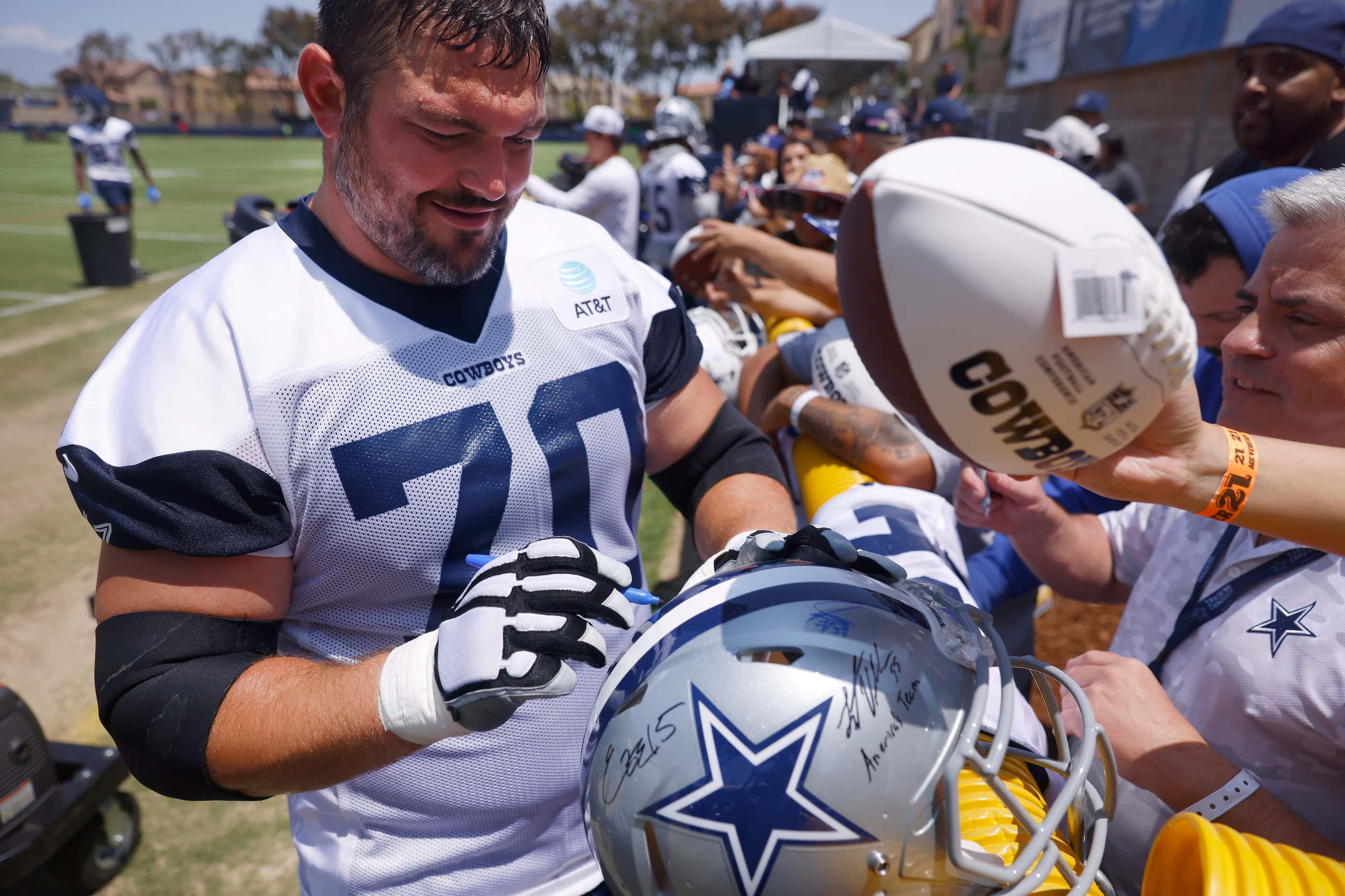 Dallas Cowboys guard Zack Martin (70) signs autographs for fans following the  opening day...