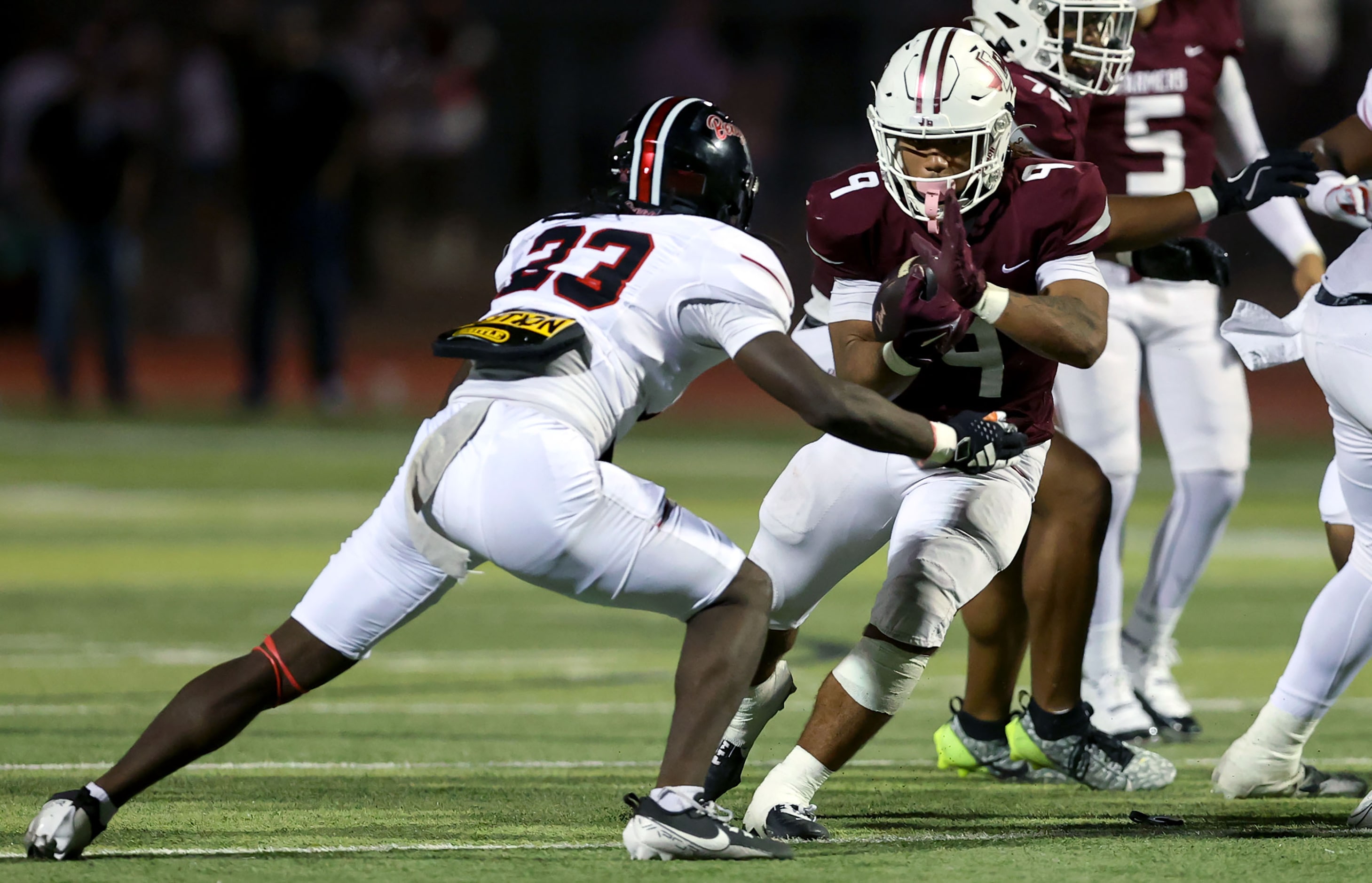 Lewisville running back Tenel Hill (9) tries to avoid getting hit by Denton Braswell...