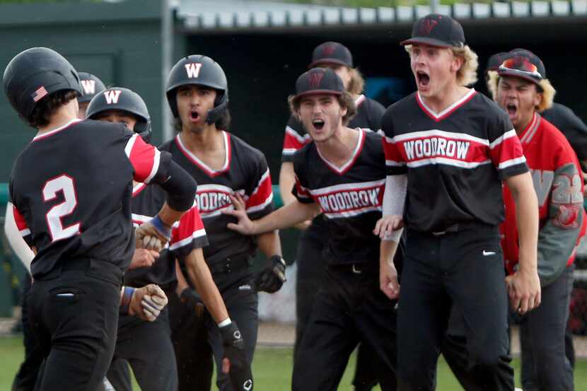 Woodrow Wilson's Ben Smith (2) celebrates with teammates after he scored a run in the top of...