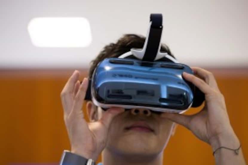  A visitor tries out a Samsung Electronics Co. Galaxy Gear Virtual-Reality (VR) headset,...