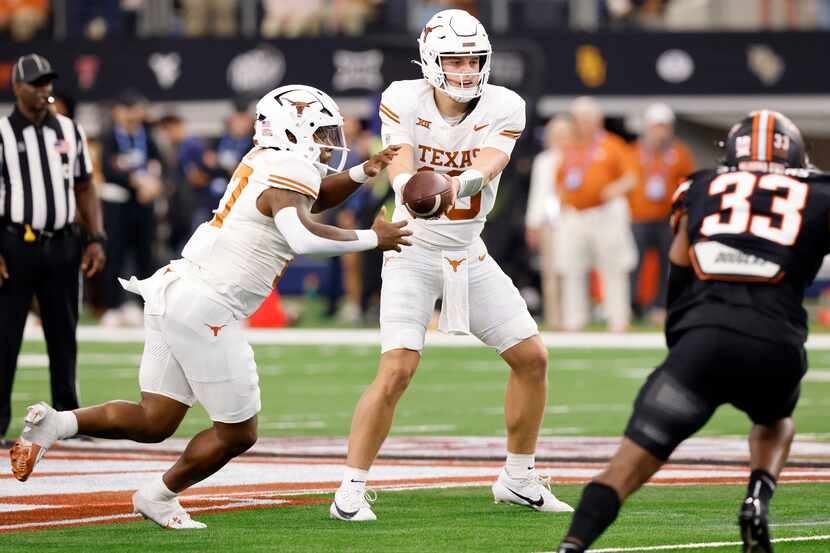 Texas Longhorns quarterback Arch Manning (16) hands the ball off to running back Savion Red...