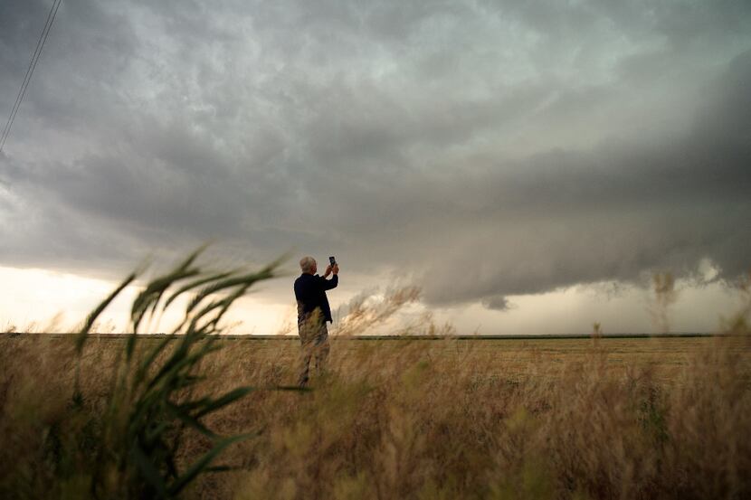 Support scientist Tim Marshall, a 40-year veteran of storm chasing, photographs a supercell...