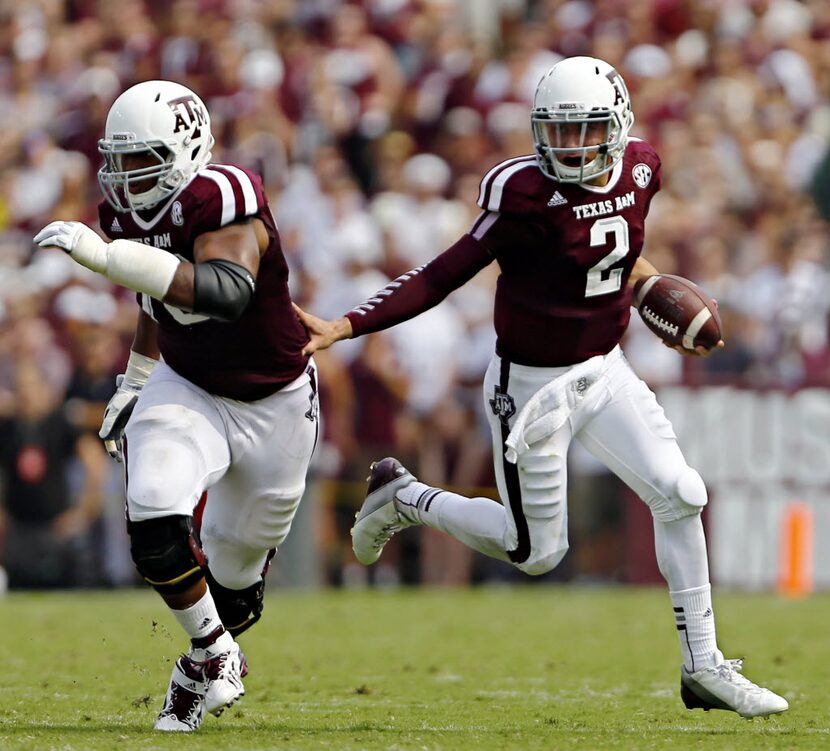 Texas A&M Aggies offensive linesman Cedric Ogbuehi (left) blocks for quarterback Johnny...