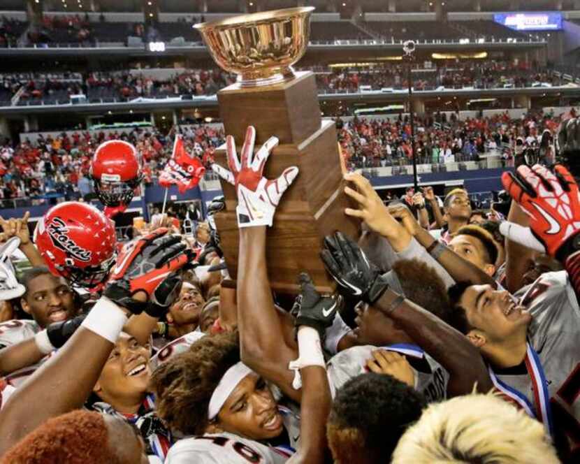 
Cedar Hill players hoist the AT&T Stadium trophy after the Longhorns' 34-24 win over Katy...