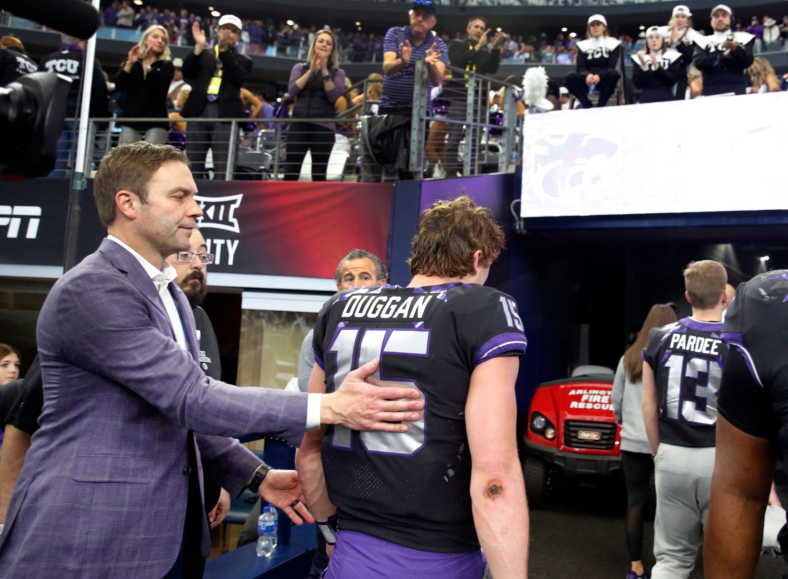 TCU Horned Frogs Director of Intercollegiate Athletics Jeremiah Donati (left) taps...