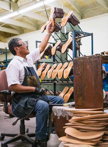 A worker removes boots from a rack at the Mercedes, Texas factory where Miron Crosby's...