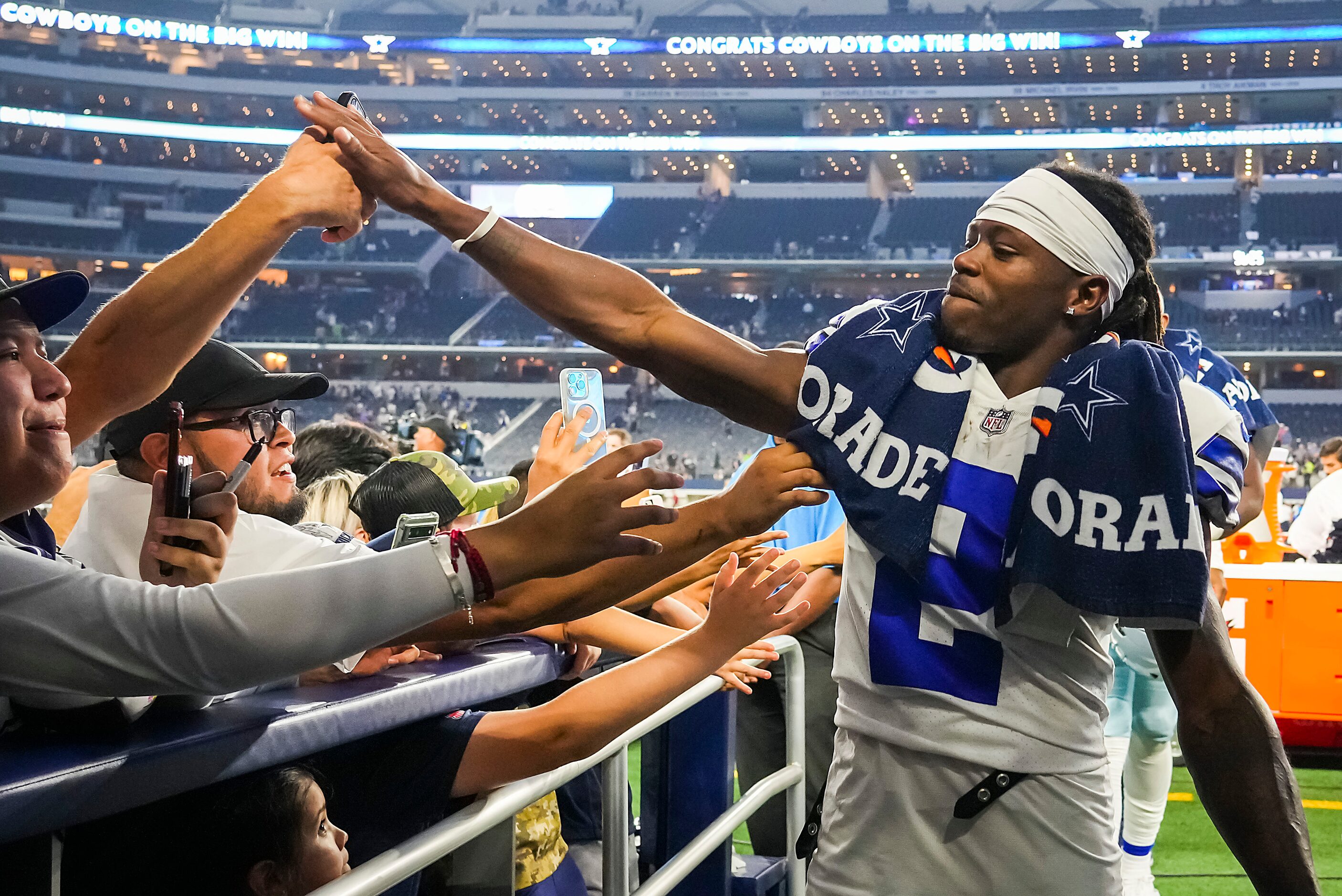 Dallas Cowboys wide receiver KaVontae Turpin high fives with fans as he leaves the field...