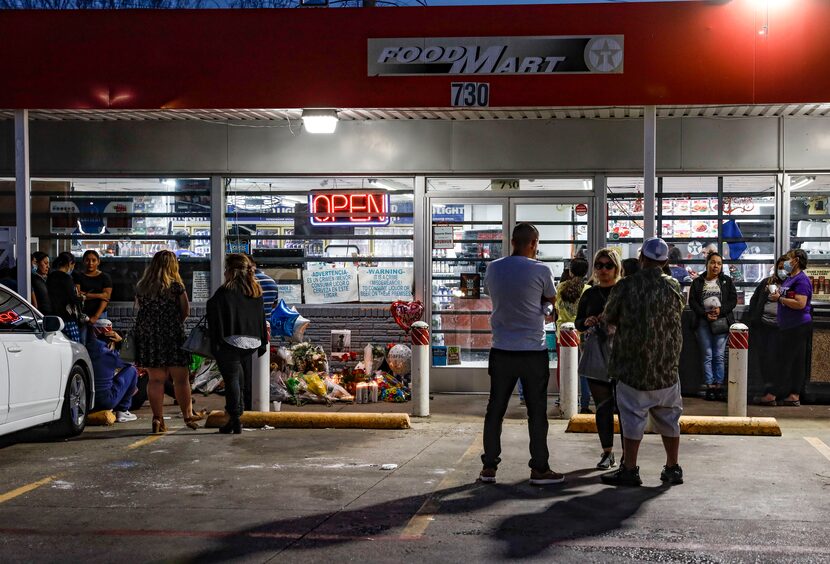 Candle wax is left on the pavement after a vigil as people disperse from the Texaco gas...