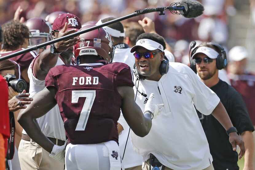 Texas A&M head coach Kevin Sumlin talks with running back Keith Ford (7) after his touchdown...