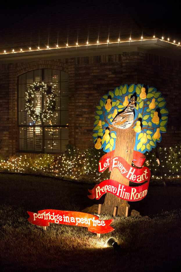 Holiday themed ornaments and lights decorate a house on Timberhollow Circle.