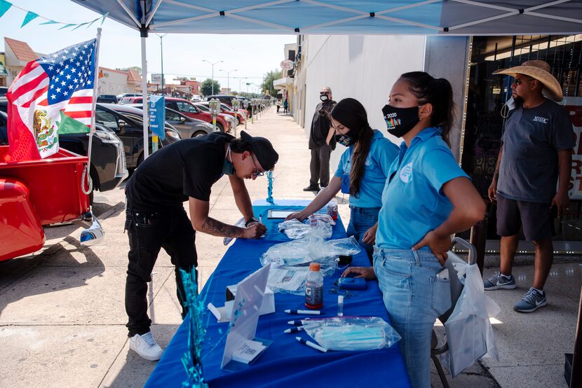 Eli Thonginh, 19, filled out raffle information at a Dallas County census booth earlier this...