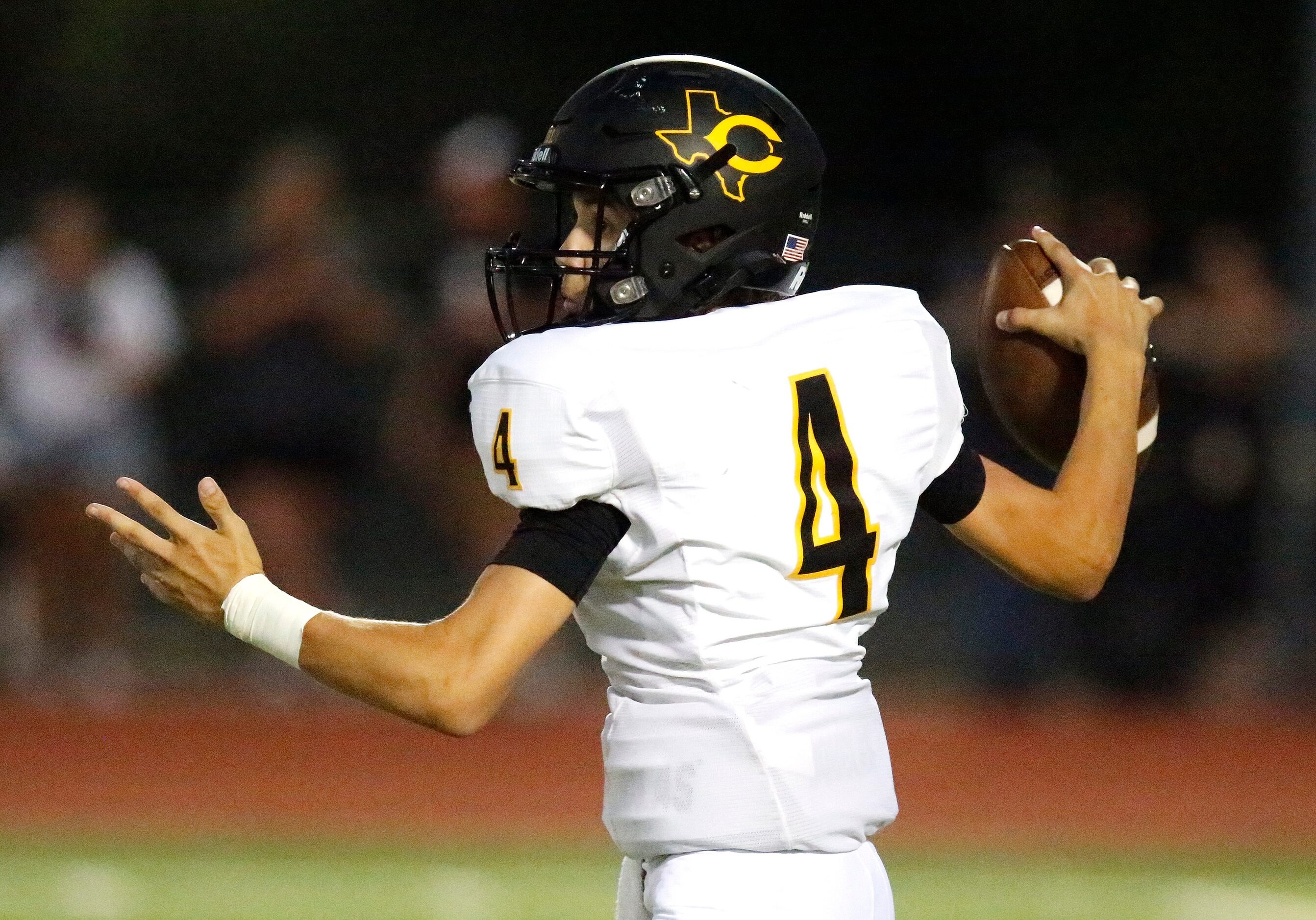 Crandall High School quarterback Gauge Wickersham (4) throws a pass during the first half as...