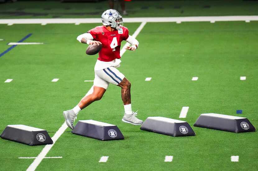 Dallas Cowboys quarterback Dak Prescott (4) runs a drill during the team’s first public...