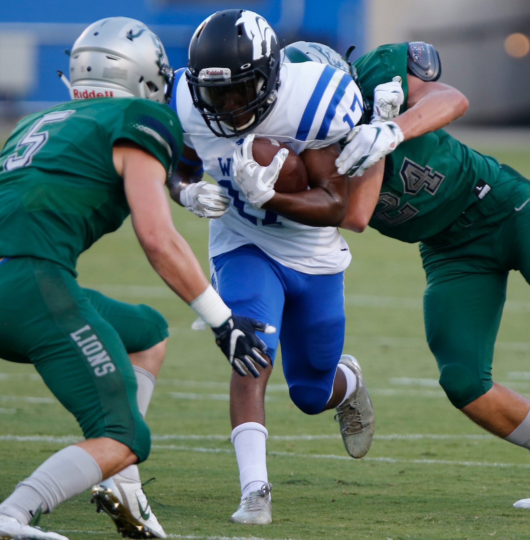 Plano West High School running back Kamryn Settles (17) is met by Reedy High School...