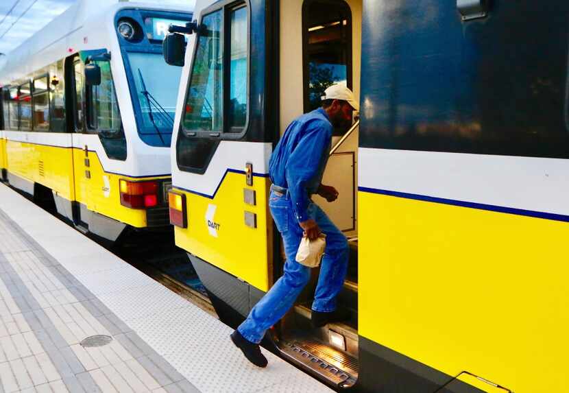 DART passenger Rodney Nelms boards a Blue Line train Monday at the UNT Dallas Station in...