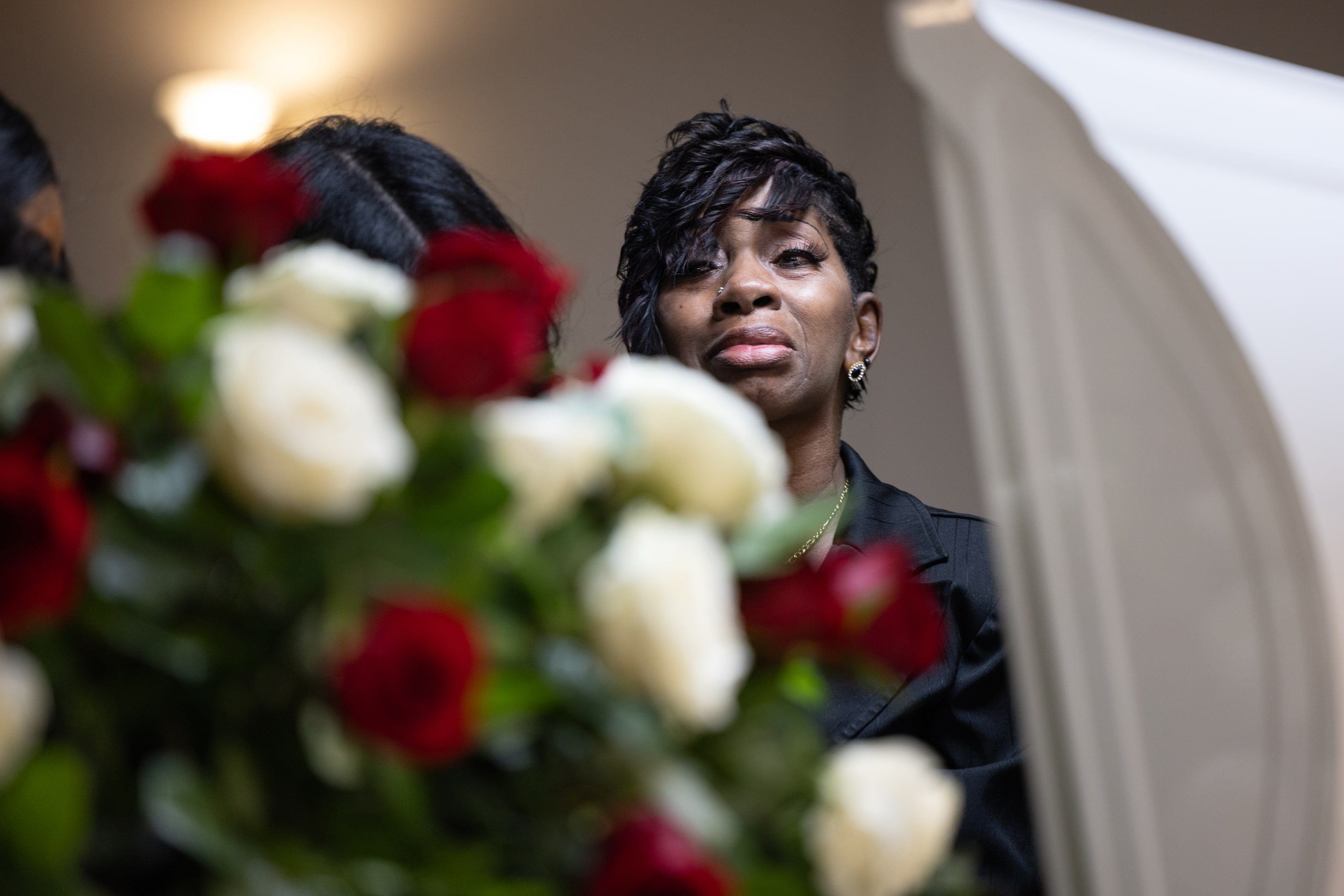 Sylvia Ware looks into the casket of her grandson, De'Maryae Daquan Hill-Young, during a...