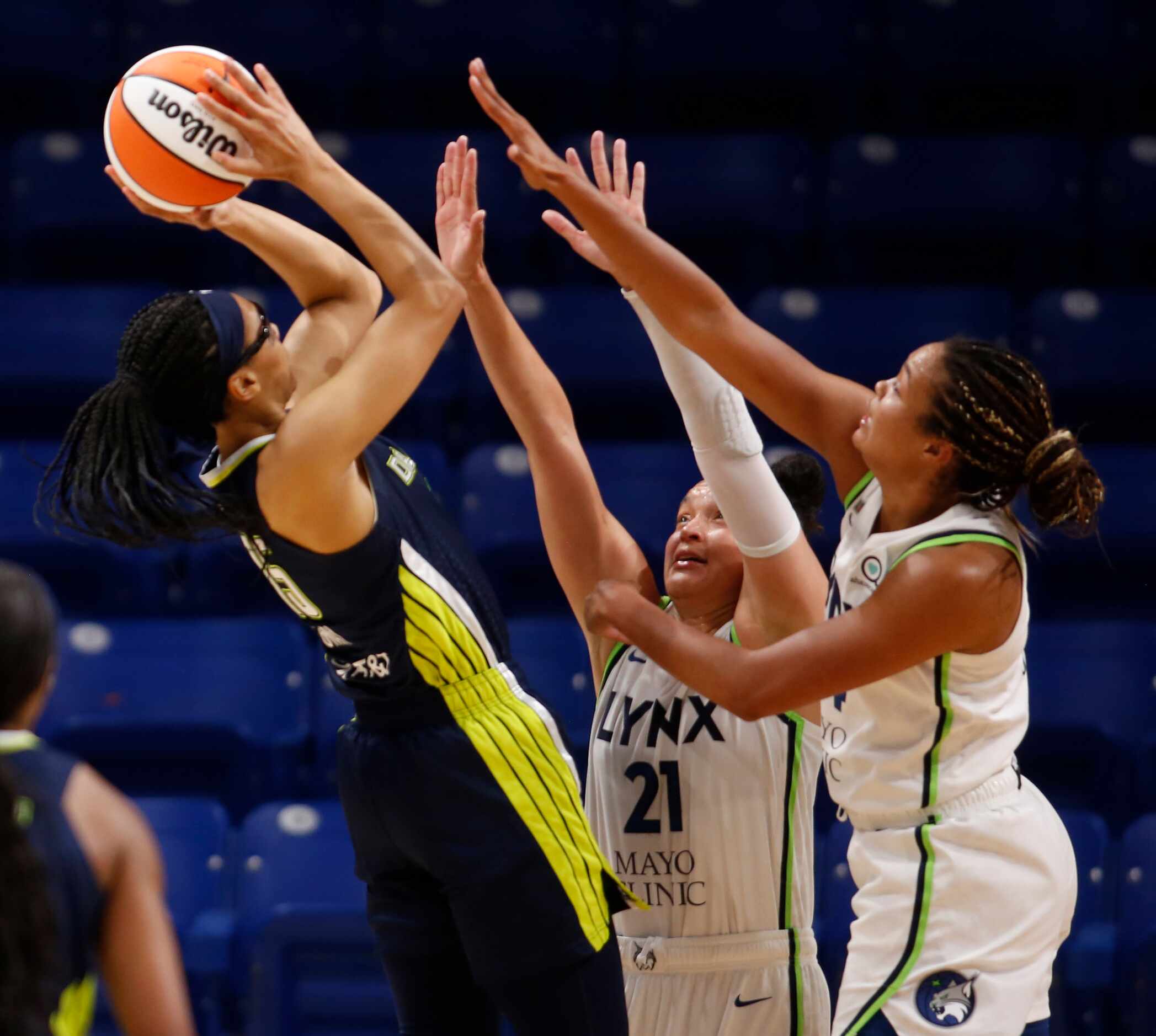 Dallas Wings guard Allisha Gray (15) goes up for a shot as she is double teamed by Minnesota...