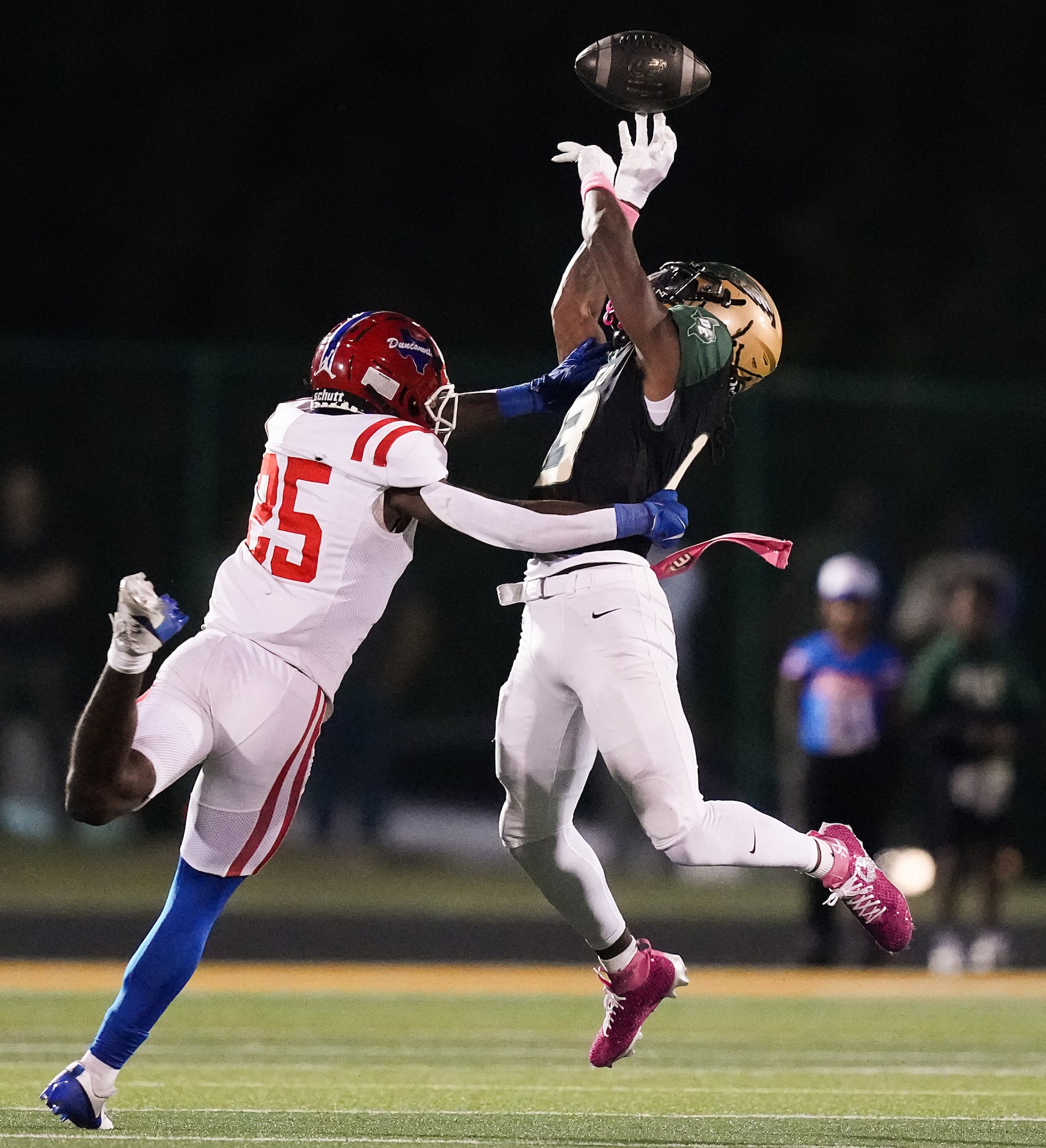 Duncanville defensive back Darrion Lyken (25) breaks up a pass intended for DeSoto wide...