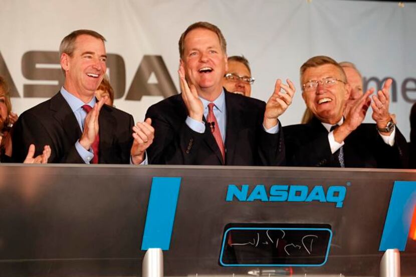 
Doug Parker (center), CEO of American Airlines Group, celebrated the listing of the newly...
