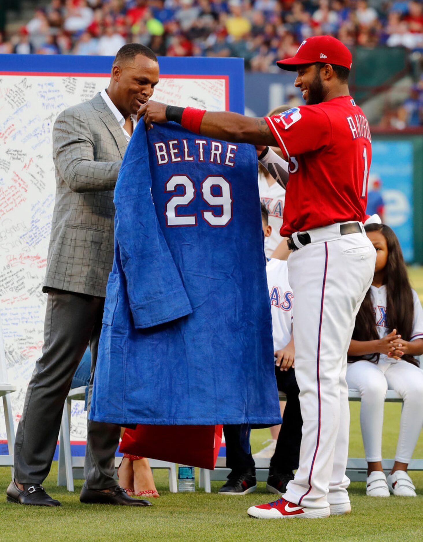 Retired Texas Rangers player Adrian Beltre, left, is presented with a gift by shortstop...