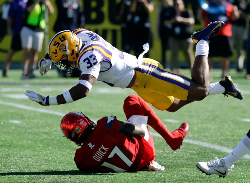 FILE - This Dec. 31, 2016, file photo shows Louisville wide receiver James Quick (17) being...