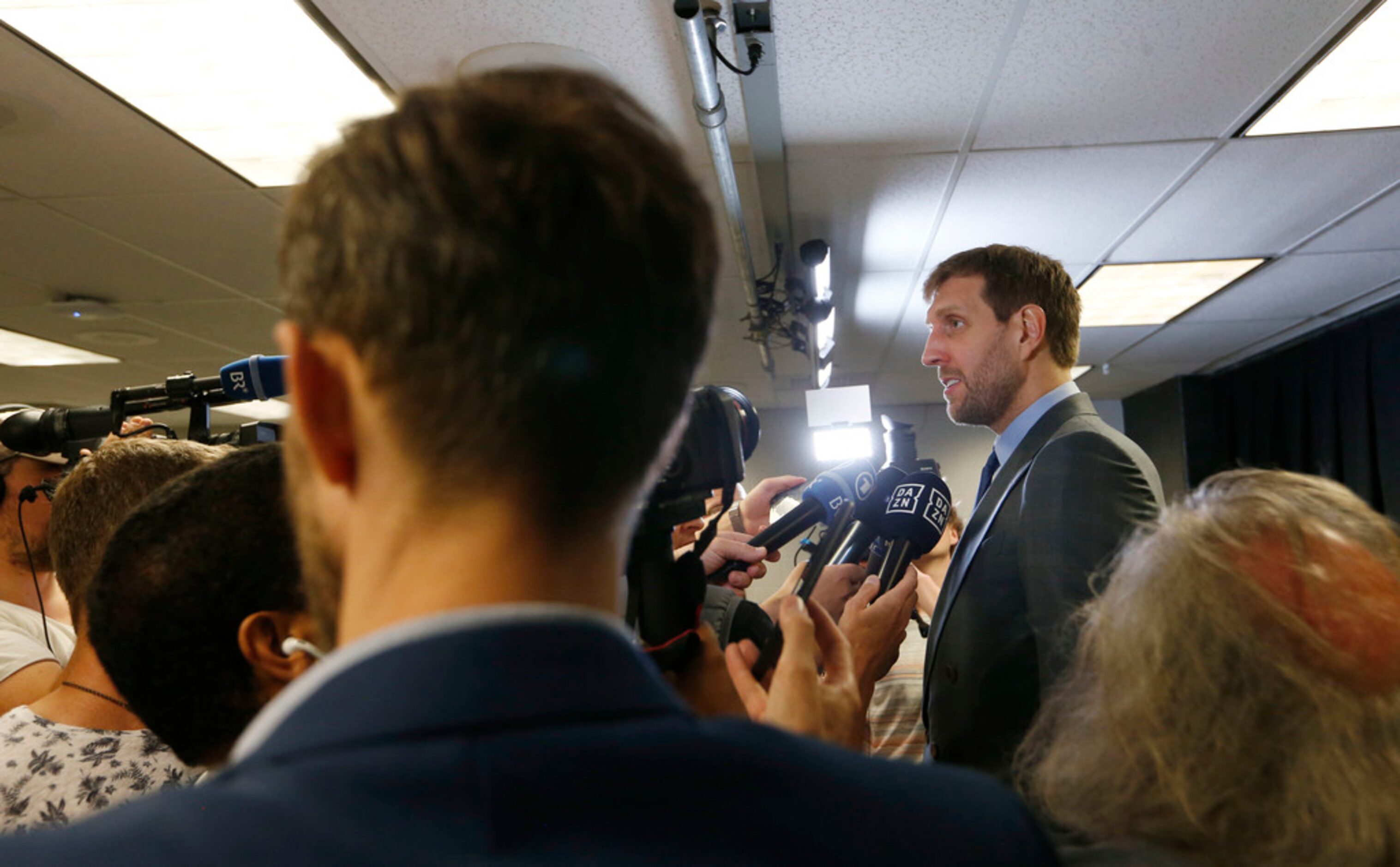 Dallas Mavericks forward Dirk Nowitzki (41) answers questions for the German media after his...