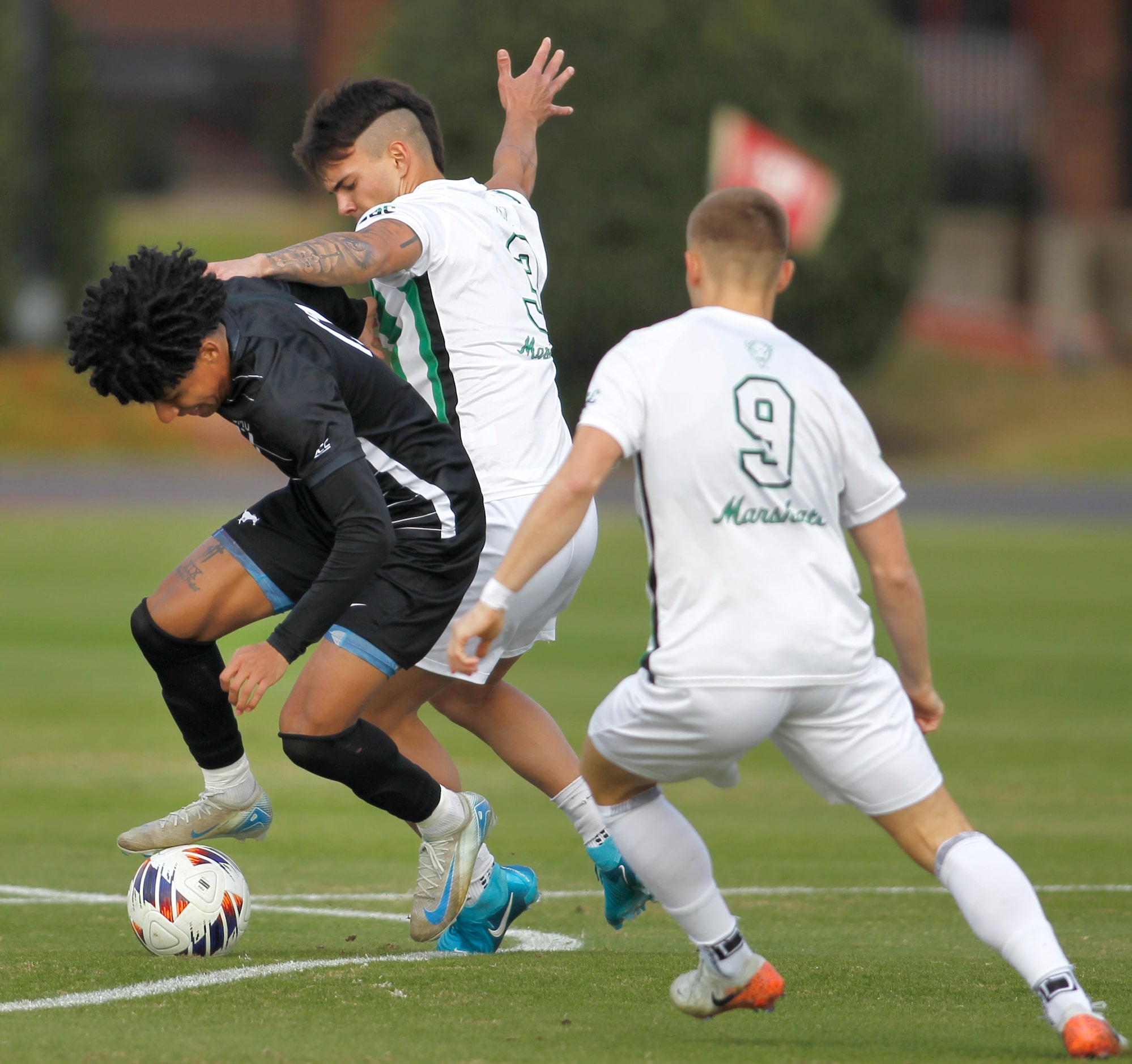 SMU Mustangs midfielder Jalinn Mitchell (17), left, works to maintain ball control as...