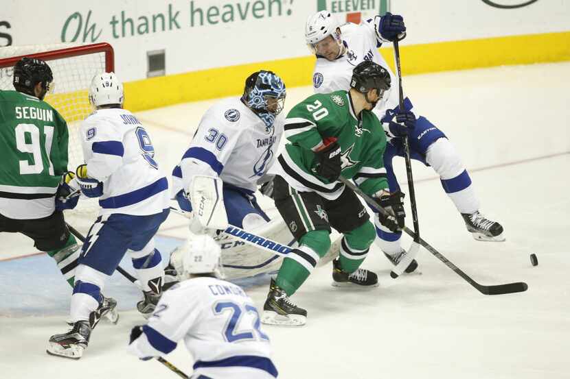 Dallas Stars center Cody Eakin (20) fights for the puck against Tampa Bay Lightning goalie...