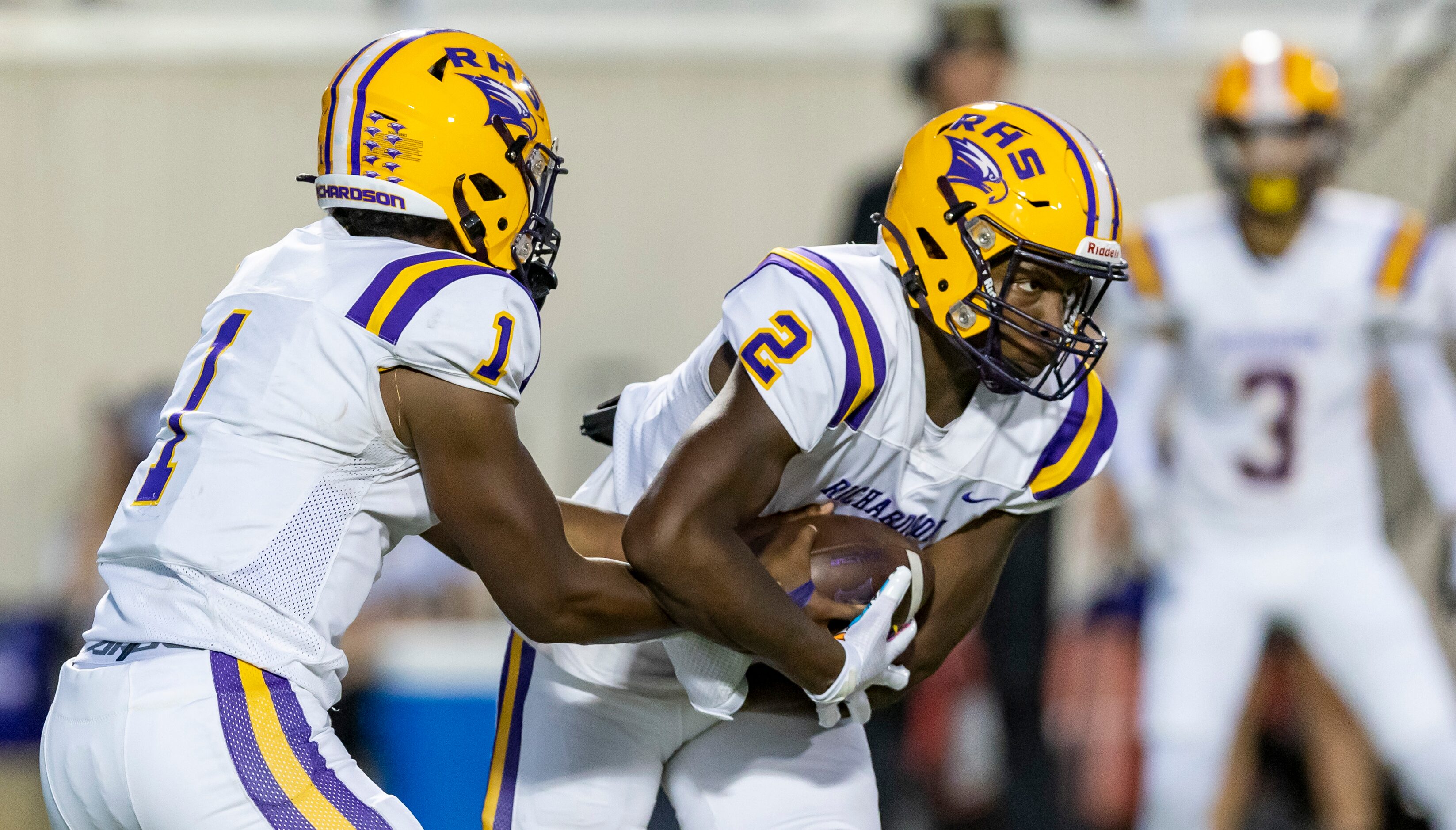 Richardson senior quarterback  Howard Armstrong (1) hands the ball off to sophomore running...