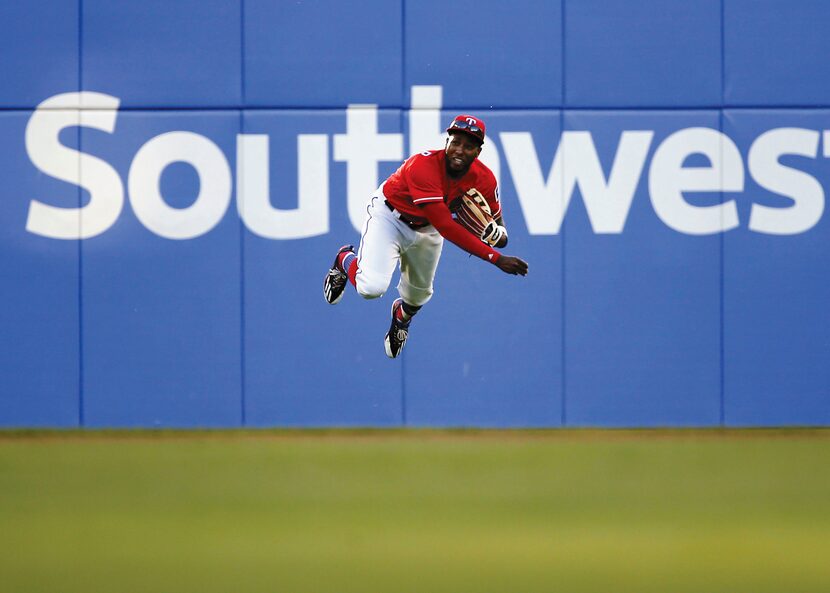 Rangers left fielder Jurickson Profar goes flying to return a ball in the third inning...