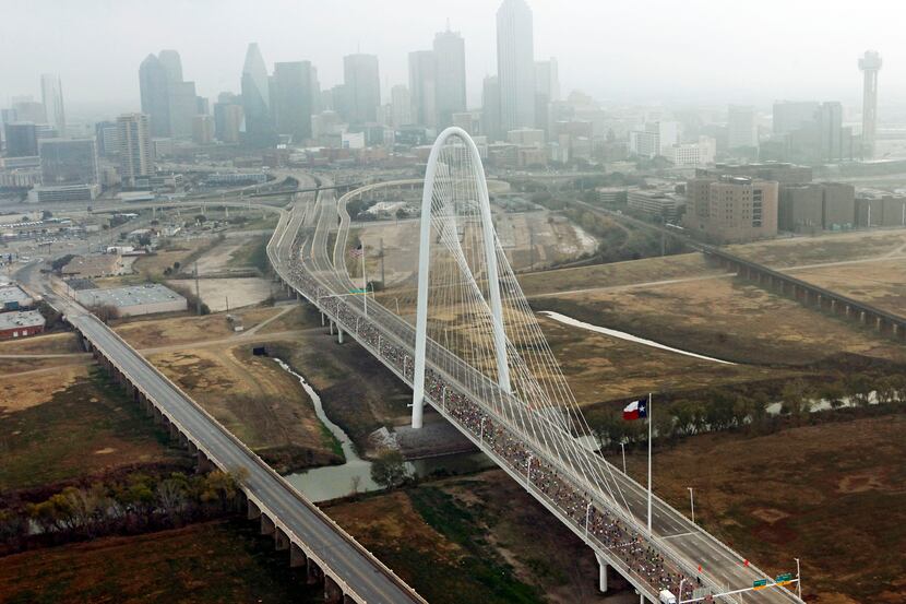 Runners make their across the Margaret Hunt Hill Bridge during the Dallas Marathon in Dallas...