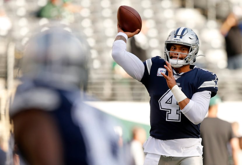 FILE - Cowboys quarterback Dak Prescott (4) warms up before a game against the New York Jets...
