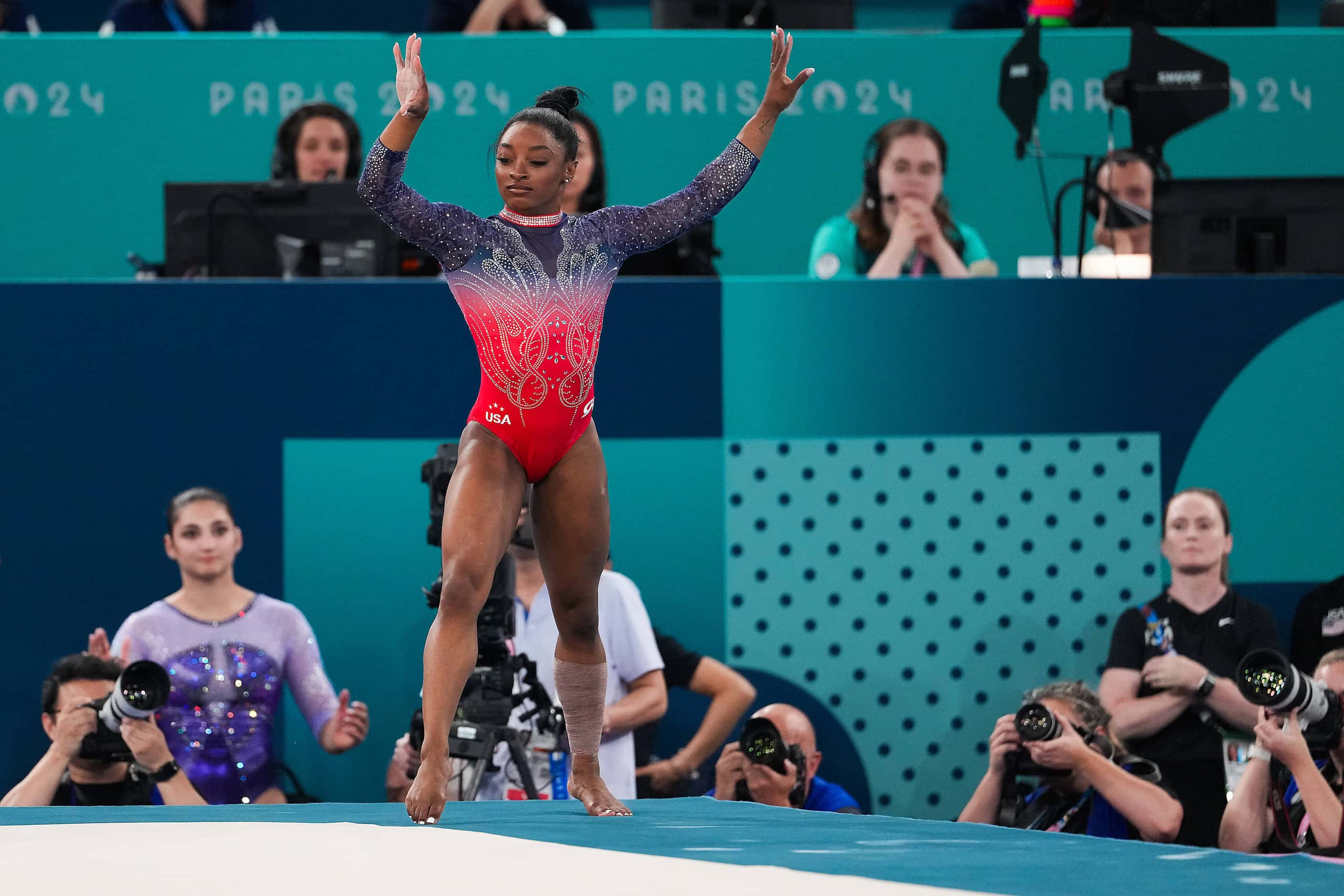 Silver medalist Simone Biles of the United States steps out of bounds as she competes in the...