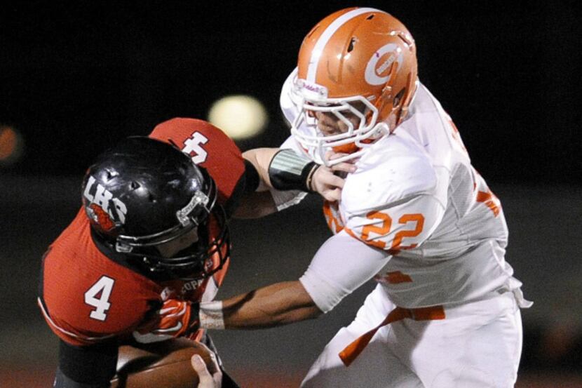 Lovejoy quarterback Zach Saffle (4) is sacked by Celina's Jesus Vargas in the first quarter...