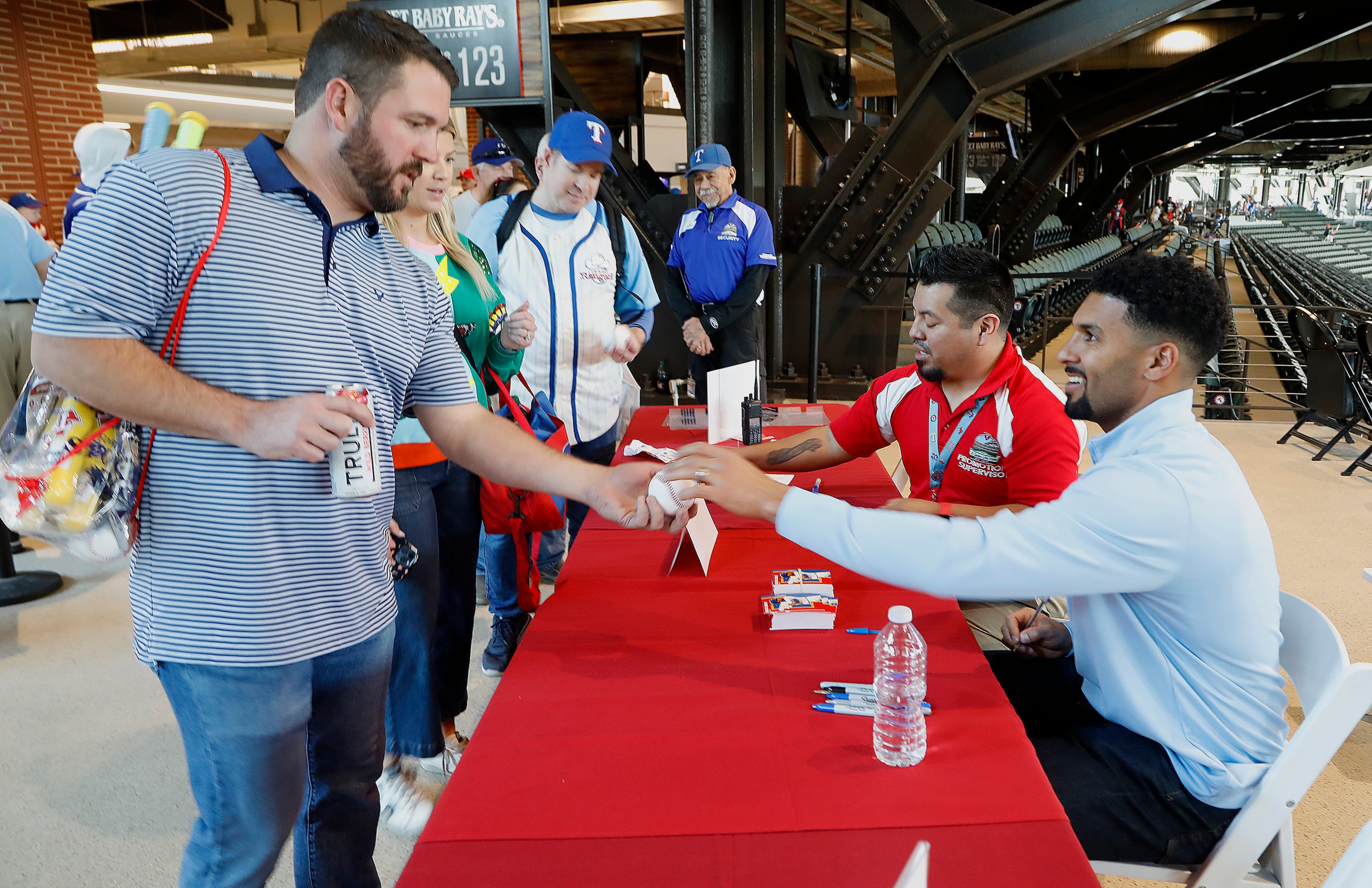 Tabor Smith (left) of Aledo gets an autograph on his baseball from Texas Rangers shortstop...