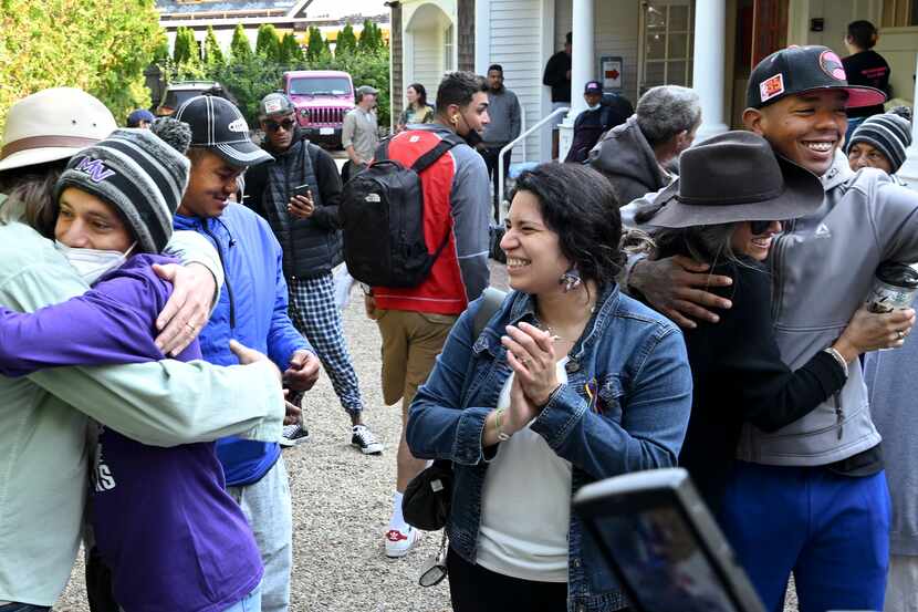 Carlos Munoz reaches out to hug Larkin Stallings of Vineyard Haven, Mass., as the immigrants...