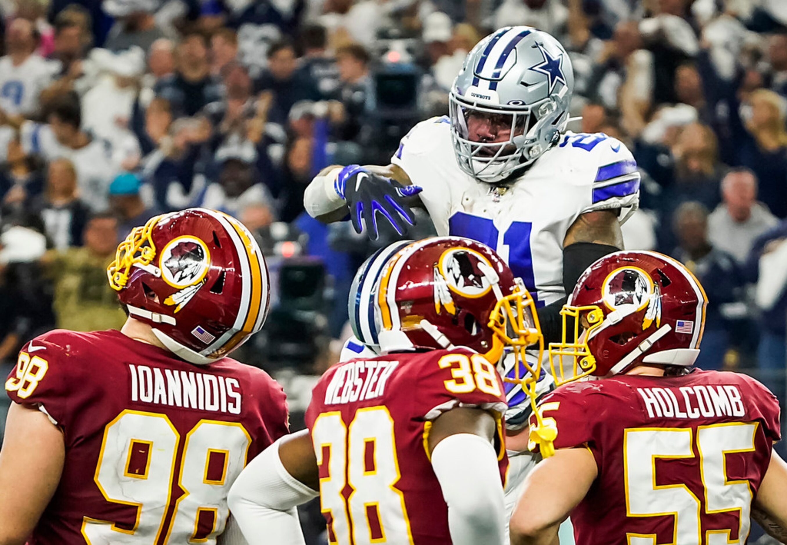 Dallas Cowboys running back Ezekiel Elliott (21) celebrates with center Travis Frederick...